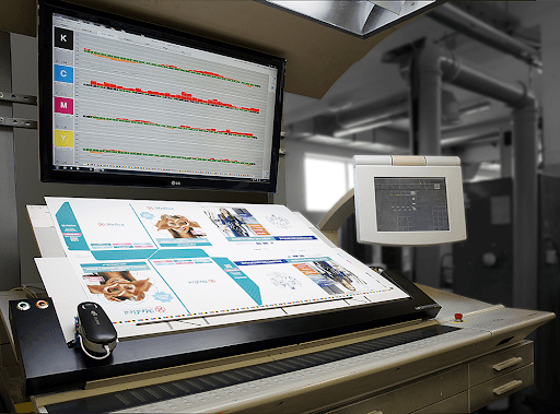 Macro shot of an offset press with digital measurement overlays (CMYK curves, scanning head, console display).