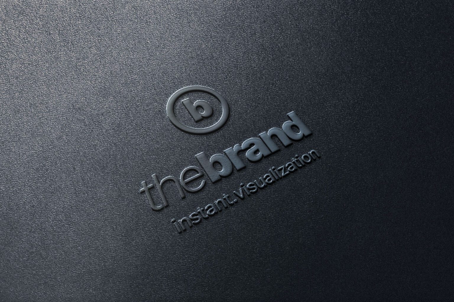 A raised blind embossing of a corporate logo and typography on a dark textured paperboard surface.