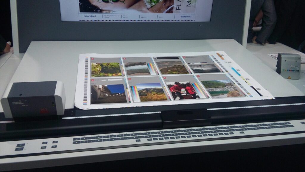 A professional press operator configuring ink zones and monitoring print quality on a modern offset printing press control console.